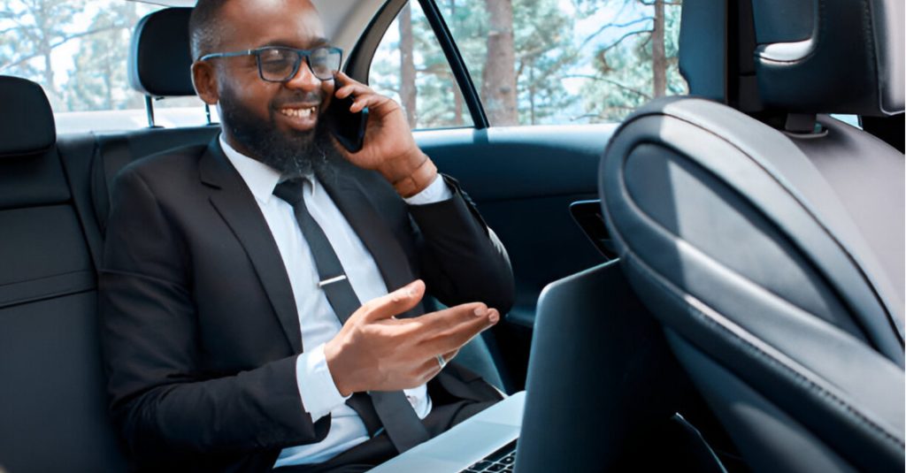 A client seated safely in a chauffeur driven car